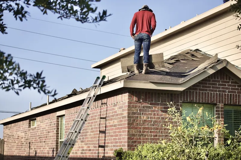 Professional roofer working on a residential roof in Ellicott City